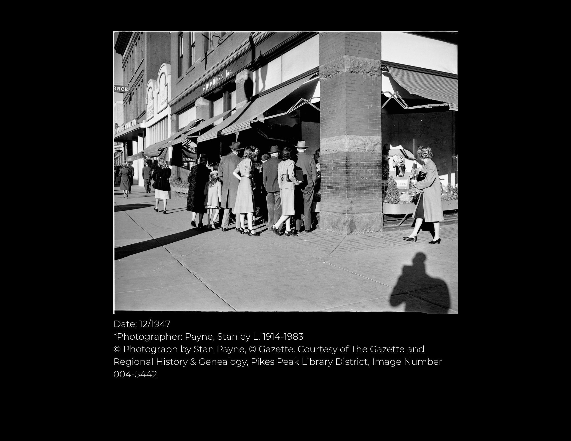 Giddings building store windows with shoppers 1947